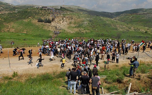 Protesters making their way across Israel's border during last year's Nakba Day demonstrations along the Syrian border (Photo credit: Hamad Almakt/ Flash 90) Protesters making their way across Israel's border during last year's Nakba Day demonstrations along the Syrian border (Photo credit: Hamad Almakt/ Flash 90)