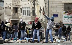 Stone-throwing Palestinians in East Jerusalem  (illustrative photo credit: Nati Shohat/Flash90)