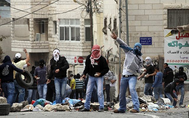 Stone-throwing Palestinians in East Jerusalem  (illustrative photo credit: Nati Shohat/Flash90)