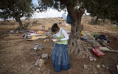 A Settler prays following a demolition of a house at the illegal outpost of Ramat Migron in August 2011 (photo credit: Yonatan Sindel/Flash90)