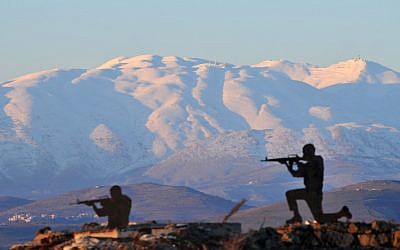 Metal silhouettes of soldiers dot the landscape overlooking the snow-covered Mount Hermon in the Golan Heights in January. (photo credit: Shay Levy/Flash 90)