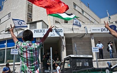 Palestinian relatives and family members demonstrate in front of the police station in Sheikh Jarrach in Jerusalem on Friday. (photo credit: Noam Moskowitz/Flash90)
