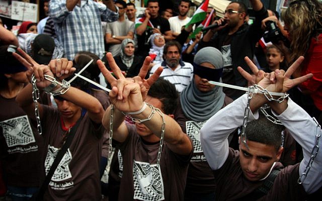 Palestinian protesters rally in support of  hunger-striking prisoners in the West Bank city of Ramallah, on Sunday (photo credit: Issam Rimawi/Flash90)