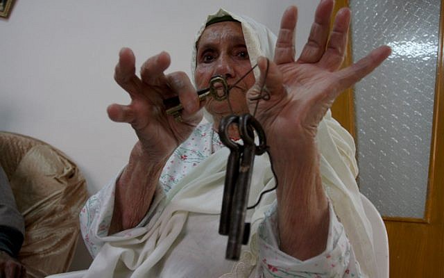 An elderly woman in the West Bank city of Ramallah displaying the keys to a previous home, before the Israeli victory in 1948. (Photo credit: Issam Rimawi/ Flash 90) An elderly woman in the West Bank city of Ramallah displaying the keys to a previous home, before the Israeli victory in 1948. (Photo credit: Issam Rimawi/ Flash 90)