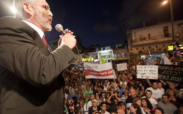 National Union MK Michael Ben Ari speaks before protesters at an anti-migrant rally in Tel Aviv, on Wednesday (Tali Mayer/Flash90)