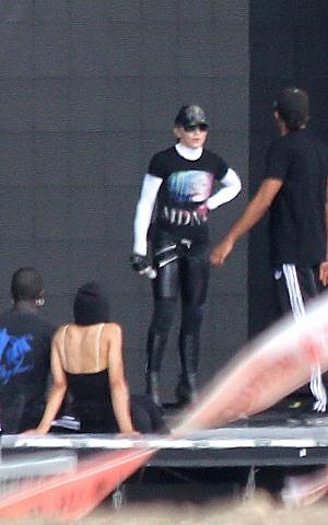 Madonna works on her choreography with a few of her backup dancers at the Ramat Gan Stadium in Tel Aviv on Monday. (photo credit: Yonatan Sindel/Flash90)