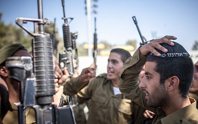 Ultra-Orthodox soldiers attend a swearing in ceremony as they enter the IDF's "Nahal Haredi" unit in June. (photo credit: Noam Moskowitz/Flash90)