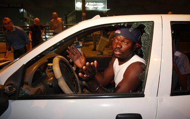 A migrant whose window was smashed during a demonstration in south Tel Aviv Wednesday. (photo credit: Roni Schutzer/Flash 90) A migrant whose window was smashed during a demonstration in south Tel Aviv Wednesday. (photo credit: Roni Schutzer/Flash 90)