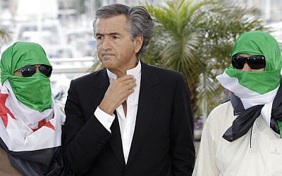 Director Bernard-Henry Levy, centre, flanked by two unidentified persons wearing Syrian flags pose during a photo call for The Oath of Tobruk at the 65th international film festival, in Cannes, southern France, Friday. (photo credit: AP)