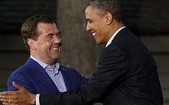 President Barack Obama (right) shakes hands with Russia's Prime Minister Dmitry Medvedev on his arrival for the G8 Summit Friday at Camp David, Md. (photo credit: AP/Charles Dharapak)