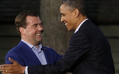 President Barack Obama (right) shakes hands with Russia's Prime Minister Dmitry Medvedev on his arrival for the G8 Summit Friday at Camp David, Md. (photo credit: AP/Charles Dharapak)