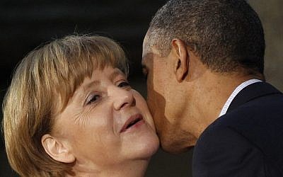 President Barack Obama kisses German Chancellor Angela Merkel on the cheek upon her arrival at the G8 Summit Friday at Camp David, Md in 2012. (photo credit: AP/Charles Dharapak)