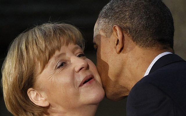 President Barack Obama kisses German Chancellor Angela Merkel on the cheek upon her arrival at the G8 Summit Friday at Camp David, Md in 2012. (photo credit: AP/Charles Dharapak)