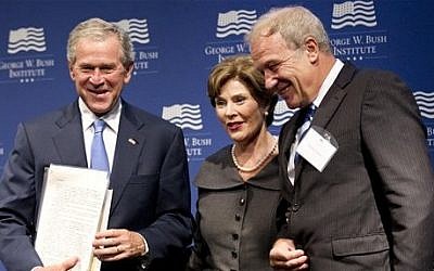 Former President George W. Bush (left), with former first lady Laura Bush, is presented with a collection of writings by former Czech President Vaclav Havel by Martin Palous (right), head of the Vaclav Havel Library Foundation, in Washington on Tuesday. (photo credit: AP/Manuel Balce Ceneta)
