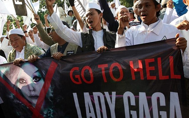 Muslim men shout slogans outside the American Embassy in Jakarta, Indonesia during a rally against pop singer Lady Gaga's scheduled concert (photo credit: Dita Alangkara/AP)