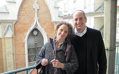 Rabbi Tamas Vero and his wife, Linda Ban Vero, outside Budapest's Frankel Leo street synagogue, where they head a growing congregation mainly made up of young families like themselves. (Ruth Ellen Gruber/JTA)