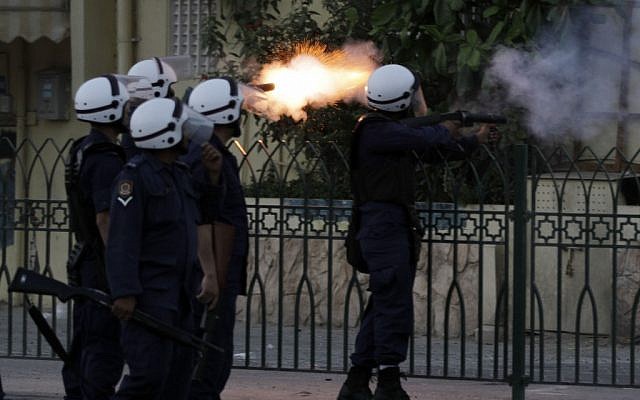 Illustrative: Riot police fire at anti-government protesters in Bahrain (photo credit: AP Photo/Hasan Jamali) Illustrative: Riot police fire at anti-government protesters in Bahrain (photo credit: AP Photo/Hasan Jamali)