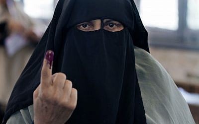 An Egyptian woman shows her inked finger after casting her vote during the first day of the presidential election in a polling station in Alexandria, Egypt, on Wednesday, May 23, 2012 (photo credit: AP/Khalil Hamra)