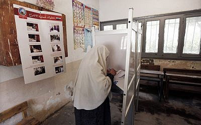 An Egyptian woman votes Wednesday, the first day of the presidential election, in a polling station in Alexandria. (photo credit: Khalil Hamra/AP)