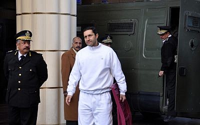 In this Jan. 24, 2012 file photo, Alaa Mubarak, center, son of former Egyptian president Hosni Mubarak arrives at the court house in Cairo, Egypt. Mubarak and his two sons are already in prison and on trial on charges of corruption. (photo credit: AP/Mohammed al-Law)