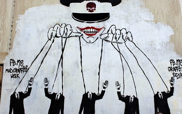 Graffiti on a wall in Cairo depicts the ruling military council controlling the presidential elections as a puppet show. (photo credit: Nasser Nasser/AP) Graffiti on a wall in Cairo depicts the ruling military council controlling the presidential elections as a puppet show. (photo credit: Nasser Nasser/AP)