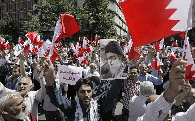 Iranians wave Bahraini flags as they chant slogans during a demonstration in Tehran  May 18, 2012 (photo credit: AP Photo/Vahid Salemi)