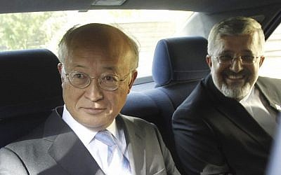 International Atomic Energy Agency (IAEA) chief Yukiya Amano, left, seen leaving his meeting with Iran's top nuclear negotiator, Saeed Jalili on Monday. (photo credit: Adel Pazzyar/IRNA/AP)