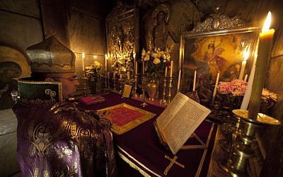 In a centuries-old tradition, clerics from the three largest denominations in the church, the Greek Orthodox, Armenians and Roman Catholics, gather each night for special prayers reserved for the men who take care of the site where Christians believe Jesus was crucified, buried and resurrected. (AP Photo/Dusan Vranic)