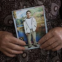 Missadeh Diab, 65, holds a picture of her son Bilal at her home in the West Bank village of Kufr Rai. Bilal Diab was arrested in August 2011 and held without charges since. Bilal is on a hunger strike since Feb. 28. (photo credit: AP/Bernat Armangue)