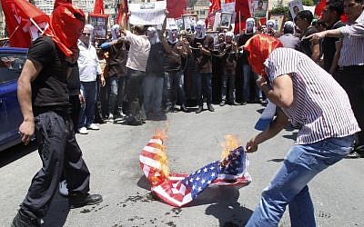 Palestinians burn an American flag during a rally to demand better conditions for Palestinian prisoners in Israeli jails, in Nablus, Saturday. (photo credit: AP) Palestinians burn an American flag during a rally to demand better conditions for Palestinian prisoners in Israeli jails, in Nablus, Saturday. (photo credit: AP)