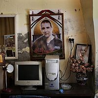 Pictures of Muhammed al-Taj, jailed in Israel and on a hunger strike since March 15, are seen at his family's house in the village of Tubas, near Jenin. (photo credit: AP/Bernat Armangue)