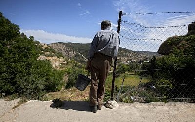 Palestinian farmer Elayan Shami, 62, stands near his field in the West Bank village of Battir. (photo credit: AP/Sebastian Scheiner)