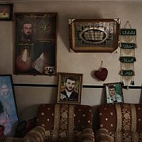 Pictures of Palestinian friends and relatives jailed in Israel are displayed on the living room of the Halahleh family house in the West Bank Village of Kharas near Hebron. Thaer Halahleh is in administrative detention for the past 24 months and is on a hunger strike for well over 70 days. (photo credit: AP/Bernat Armangue)