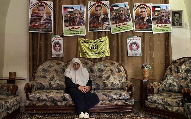 Dalal, mother of Mohammed al-Taj, sits underneath posters showing her son at their family house in the West Bank village of Tubas. (photo credit: AP/Bernat Armangue) Dalal, mother of Mohammed al-Taj, sits underneath posters showing her son at their family house in the West Bank village of Tubas. (photo credit: AP/Bernat Armangue)