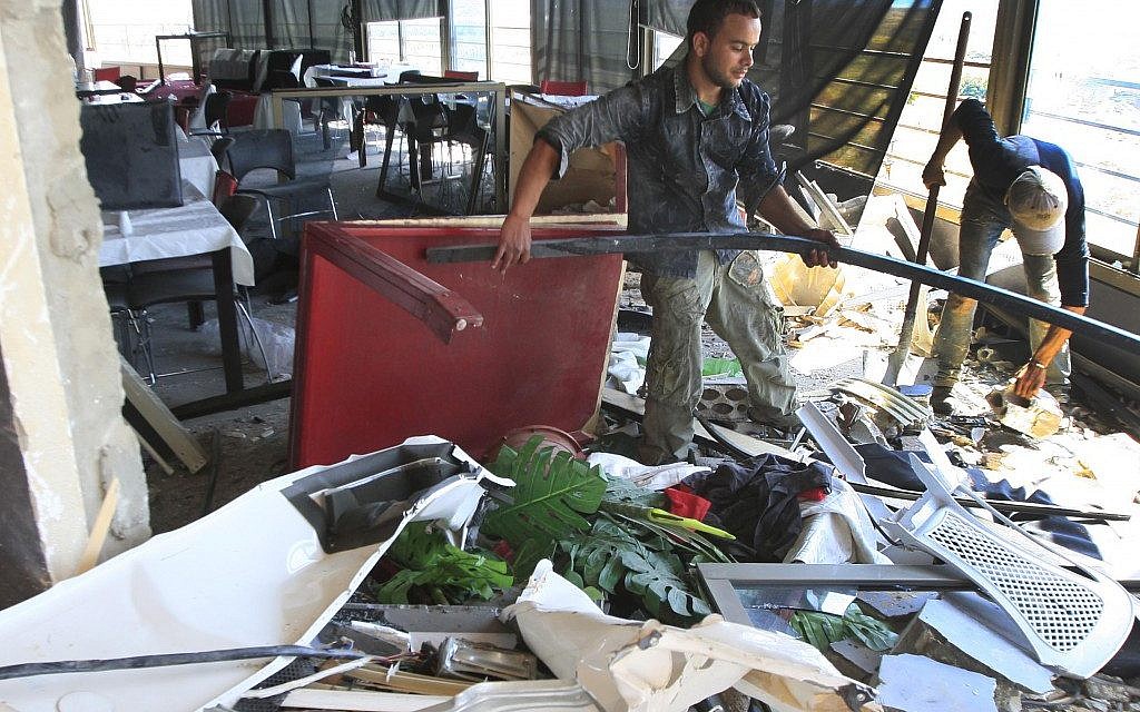 Workers remove debris from a south Lebanon restaurant which was bombed because it serves alcohol (photo credit: AP Photo/Mohammed Zaatari) Workers remove debris from a south Lebanon restaurant which was bombed because it serves alcohol (photo credit: AP Photo/Mohammed Zaatari)