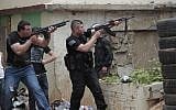 Sunni gunmen fire their rifles during clashes, in the northern port city of Tripoli, Lebanon, Sunday. (photo credit: AP/Hussein Malla)