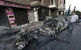 Burnt vehicles in Beirut following clashes between supporters and opponents of the Assad regime (photo credit: AP/Hussein Malla)