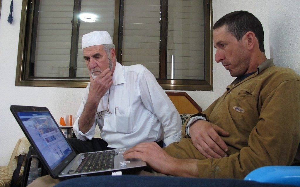 Mohammed Faour, right, and his father, Amin, who live in the village of Shaab in northern Israel, looking for relatives on Facebook. (photo credit: AP/Ben Hubbard) Mohammed Faour, right, and his father, Amin, who live in the village of Shaab in northern Israel, looking for relatives on Facebook. (photo credit: AP/Ben Hubbard)