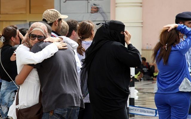 Family members of victims react in grief after a fire took hold of the Villaggio Mall in the Qatari capital of Doha on Monday. (photo credit: Osama Faisal/AP)