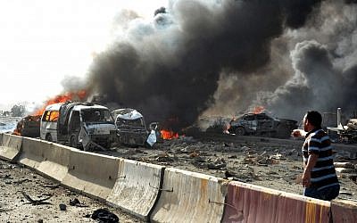 Flames and smoke rise from burned cars after two bombs exploded in Damascus, Syria, in early May (photo credit: AP/SANA)