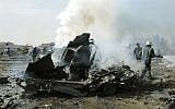 Syrian firefighters extinguish a burning car following explosions in Damascus (photo credit: AP Photo/SANA)