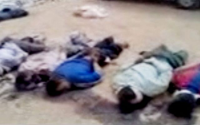 Illustrative: This image made from amateur video released by the Shaam News Network and accessed Tuesday purports to show 13 blindfolded and handcuffed bodies on the ground in Deir el-Zour, Syria. (photo credit: Shaam News Network/AP)