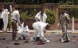 Forensic experts collect evidence at the site of the explosion in Sanaa, Yemen (photo credit: AP Photo/Hani Mohammed)