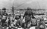 Mordechai 'Motta' Gur (seated, with black curly hair) and his troops survey the Old City before launching their attack, May 1967. (photo credit: Wikimedia Commons CC BY-SA/Mazel123)