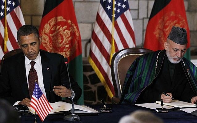 US President Barack Obama and Afghan President Hamid Karzai sign a strategic partnership agreement in May (photo credit: AP/Charles Dharapak)