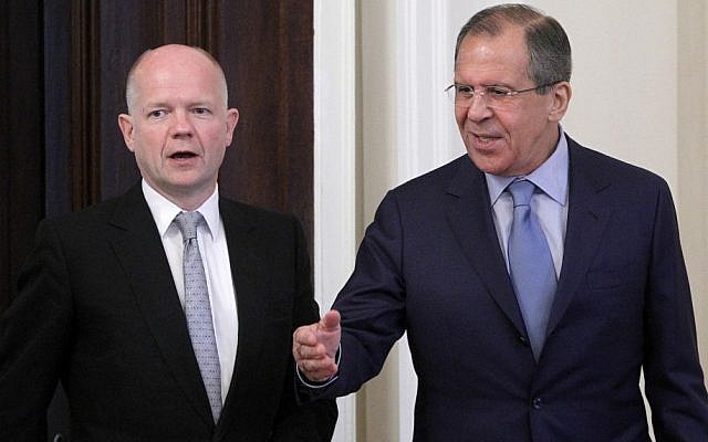Russian Foreign Minister Sergey Lavrov (right) welcomes his British counterpart William Hague during their meeting on the Syrian crisis in Moscow on Monday (photo credit: AP/Misha Japaridze)