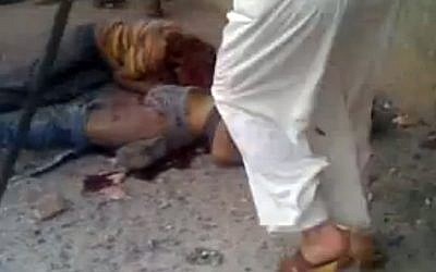 This frame grab made from an amateur video provided by Syrian activists on Monday purports to show the massacre in Houla on Friday that killed more than 100 people, many of them children (photo credit: AP/Amateur Video via AP video)