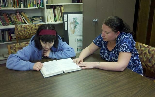 Student Emma Weihrauch with tutor Leanne Pelser at Temple Beth Emunah in Brockton, Mass. The temple offers children with attention deficit hyperactivity disorder special programs to help them study for their bar/bat mitzva ceremonies. (photo credit: Temple Beth Emunah/JTA)