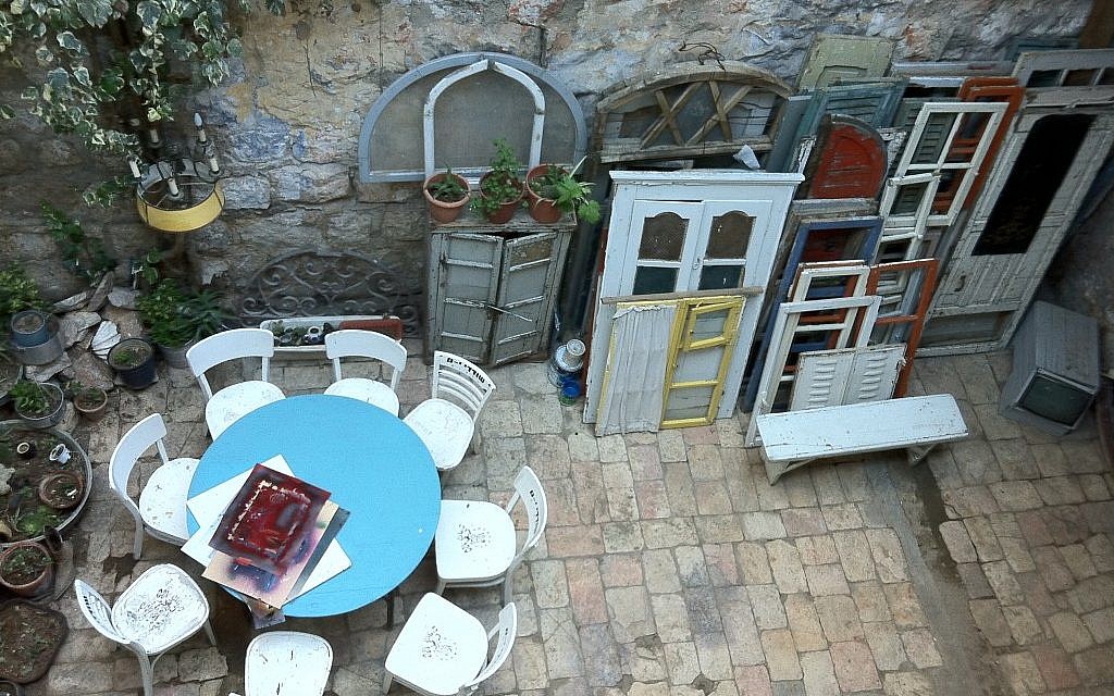 Salvaged frames and doors in the Tower and Story Museum and Robbers of Jerusalem Gallery's outdoor sitting area. (Photo credit: Greg Tepper)