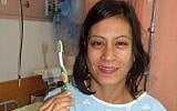 Deep cleaning: Bat-El Panker and the offending toothbrush (photo credit: Carmel Hospital)